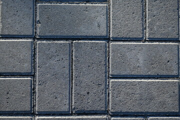 grey paving slabs as a background, symmetrical paving slabs close up 