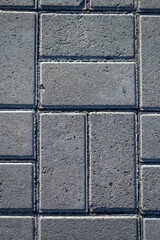 grey paving slabs as a background, symmetrical paving slabs close up 