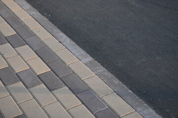 Fototapeta premium grey paving slabs as a background, symmetrical paving slabs close up 