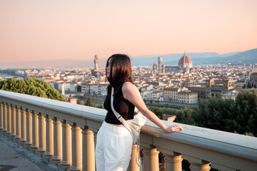 Young Central Asian Woman at Piazzale Michelangelo (Michelangelo square) looking over Florence...