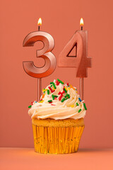 Birthday cake with candle number 34 - Coral fusion background