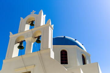 White orthodox church blue dome of the Oia santorini greece
