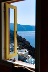 santorini house window view of the oia caldera and cycladic white houses aegean sea greece