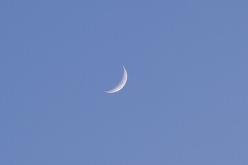 Waxing crescent moon phase at the sky background wallpaper.