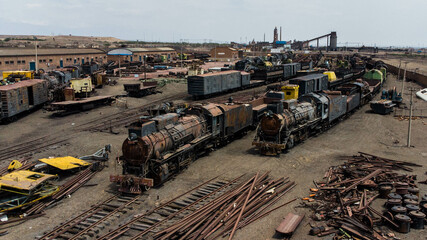 train yards with abandoned steam locomotives