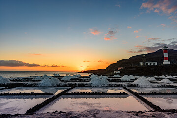 Sunset at the salt flats directly on the Atlantic coast. The sea salt shines romantically in the...