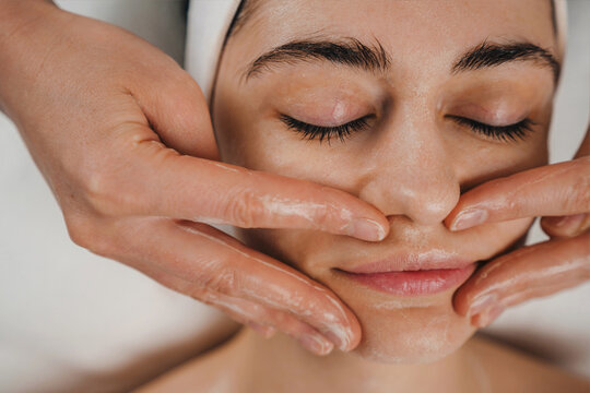 Crop Ethnic Woman Applying Cream On Face