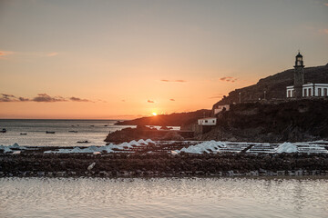 Sunset at the salt flats directly on the Atlantic coast. The sea salt shines romantically in the light