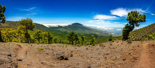 Clouds move over the mountain slope of Cumbre Nueva and flow into the valley like a waterfall, La Palma, Canary, Spain, Europe
