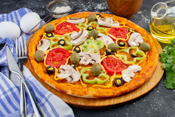 front view spicy mushroom pizza with red tomatoes bell peppers olives and mushrooms all sliced inside with oil and greens on the dark desk food pizza dough