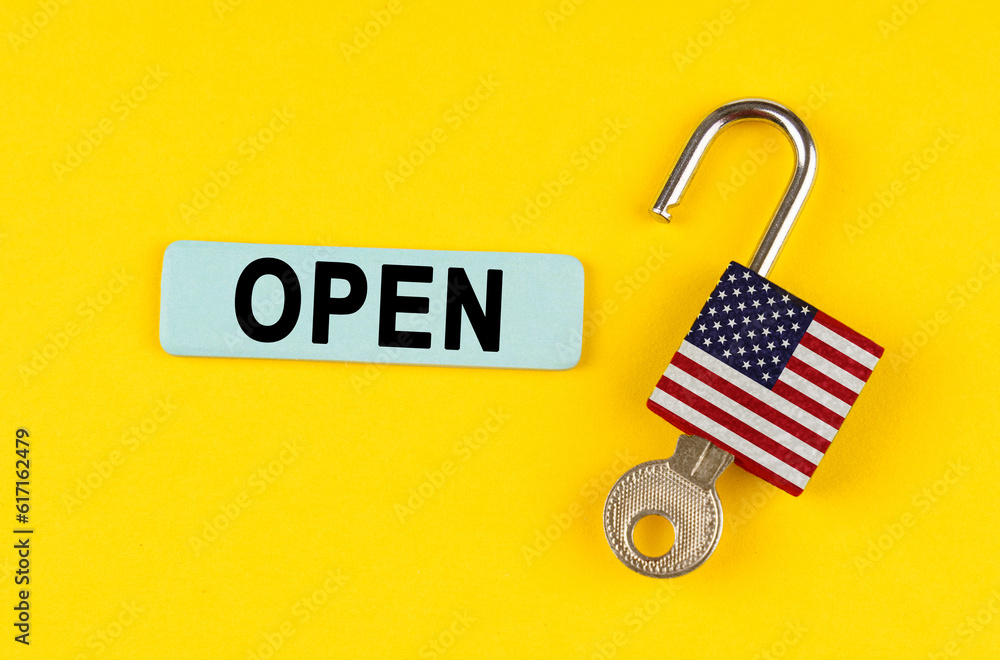 Poster On the yellow surface is an open lock with a key and a sticker with the inscription - open