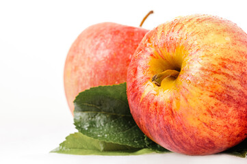 Red apple with a green leaf. Isolated on white background