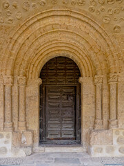 Fototapeta na wymiar Richly decorated church porticos with a semicircular arch and two columns