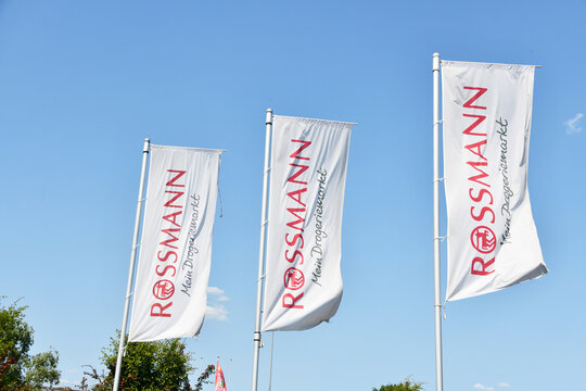 Berlin, Germany - June 5, 2023: Flags with the logo of Rossmann in Berlin, Germany - Dirk Rossmann GmbH is Germany's second-largest drogerie store chain