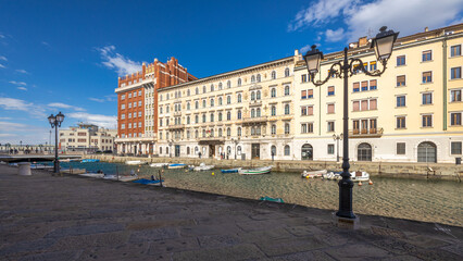 Fototapeta na wymiar The Canal grande with the Gopcevich palace, a navigable canal in center of Trieste, Italy, Europe.