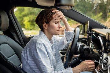 Tired woman stopped after driving car. Pensive sad middle aged female thinking about life troubles,...