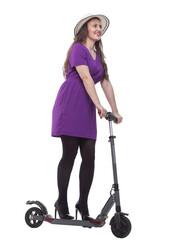 full length . fashionable young woman with a scooter.