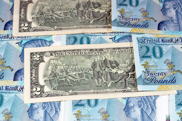 Background of USD American dollars money bills with the new Egyptian 20 EGP LE twenty polymer...