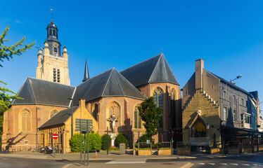 View of Sint-Michielskerk parish church with tall bell tower in Belgian town of Roeselare on sunny summer day, West Flanders