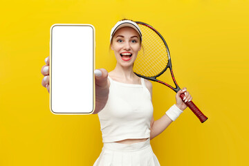 tennis player girl in sportswear holding tennis racket and showing blank screen of smartphone