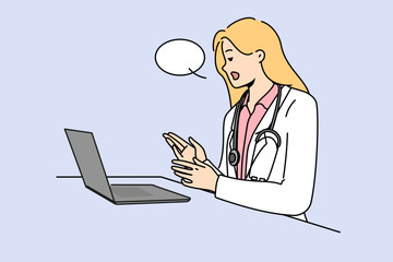 Doctor with laptop provides telemedicine services by consulting patients via internet. Woman telemedicine specialist in white remotely examines patient and gives recommendations for treatment