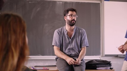 High school teacher teaching students subject matter of course. Classmates in shared classroom at international school. Young multiracial people learning new concepts at the university. - Powered by Adobe