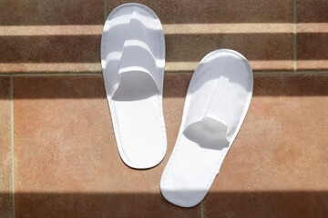 Blank white hotel slippers. Towelling disposable spa guest shoes. Top view