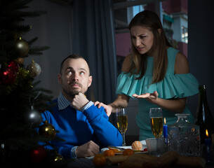 Angry man and woman quarreling during Christmas night