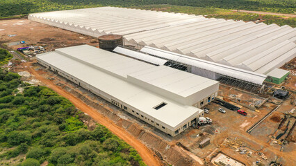 Aerial Dron view of huge warehouse building, Paredes con azulejos en construcción, Ventilador, techo con luces suaves y alarme de incendios, Construction maison, white walls, mock ups.