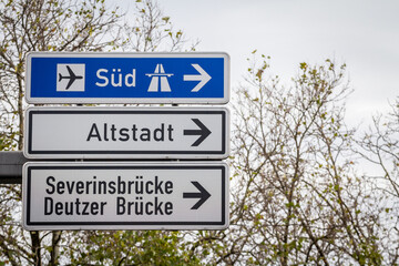 Obraz premium Selective blur on german roadsign in Cologne, Germany, directing to autobahn motorway heading south (Sud in German) & local road to Cologne districts of Severinsbrucke, Altstadt & Deutzer Brucke.