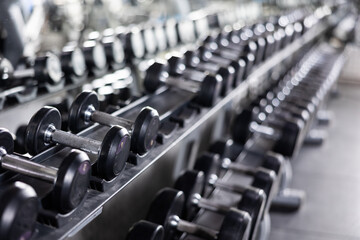 Fototapeta na wymiar Rows of dumbbells for weight training in gym