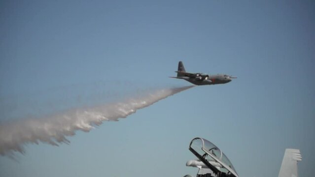 C130 Airplane dropping water in slow motion