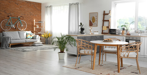 Modern studio apartment interior with kitchen and sofa