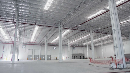 Concrete floor inside industrial building. Use as large factory, warehouse, storehouse, hangar or...