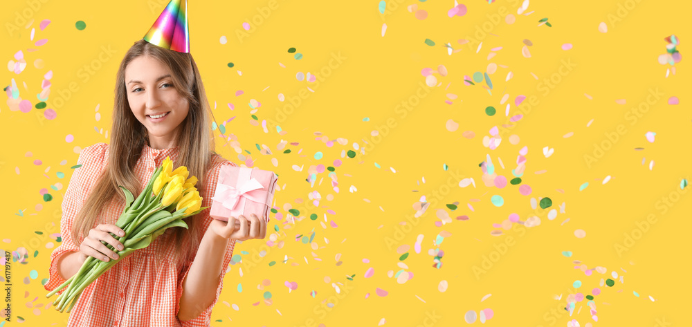 Sticker happy young woman with birthday gift and tulips on yellow background. banner for design