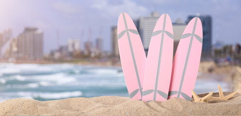 Small surfboards on beach sand