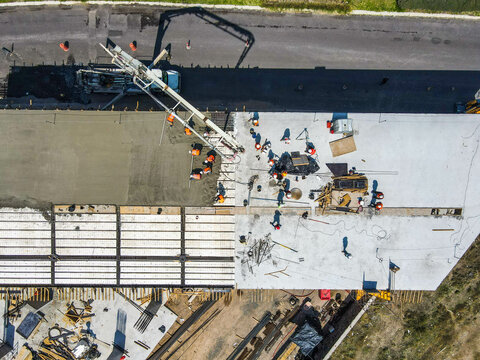 Aerial View Of Construction Site. Four Construction Workers Having Meeting,stock Photo