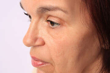 Closeup view of older woman on white background