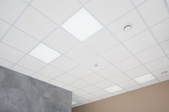 White ceiling with modern lighting in room, low angle view