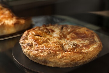 Delicious pie with tasty filling on counter in bakery shop, closeup. Space for text