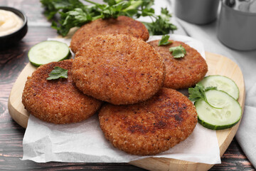 Tasty vegan cutlets served on wooden table, closeup