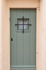 Fototapeta na wymiar old wooden door, green color front door