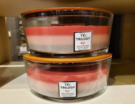 Lewes, Delaware, U.S - June 18, 2023 - A pink WoodWick Trilogy candle with the scent of Melon Blossom, Coastal Sunset and Palo Santo