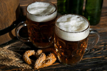 Mugs of cold beer on wooden background. Oktoberfest celebration