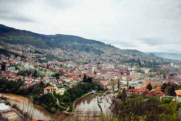 Panoramic view of the spring city of Sarajevo, Bosnia and Herzegovina. A trip to a European city in the mountains with orange roofs.
