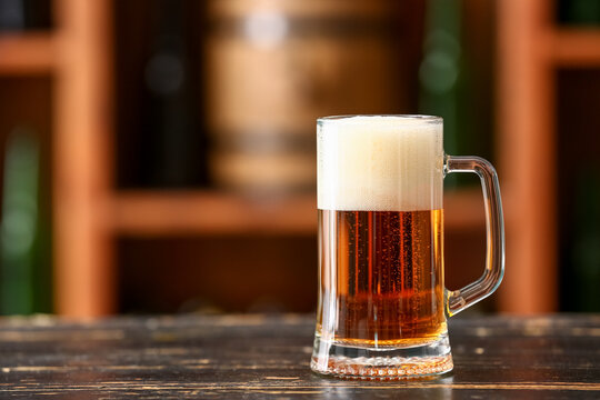 Mug of beer on table in bar. Oktoberfest celebration