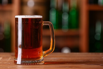 Mug of beer on table in bar. Oktoberfest celebration