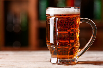 Mug of beer on table in bar. Oktoberfest celebration