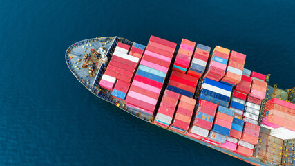 Aerial top view Cargo Ship carrying container and running for export goods from cargo yard port to other ocean concept freight shipping ship .