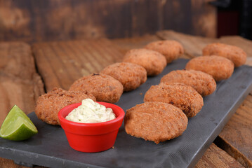 Fried and breaded codfish cake, fish empanadas, codfish cake, Brazilian-style codfish cakes, meat disc